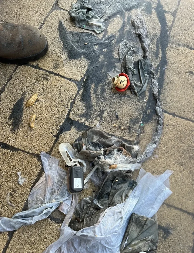 Burnt debris and melted items on the ground.